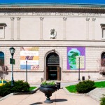 Charles Street entrance to the Walters Art Museum, green grounds in front.